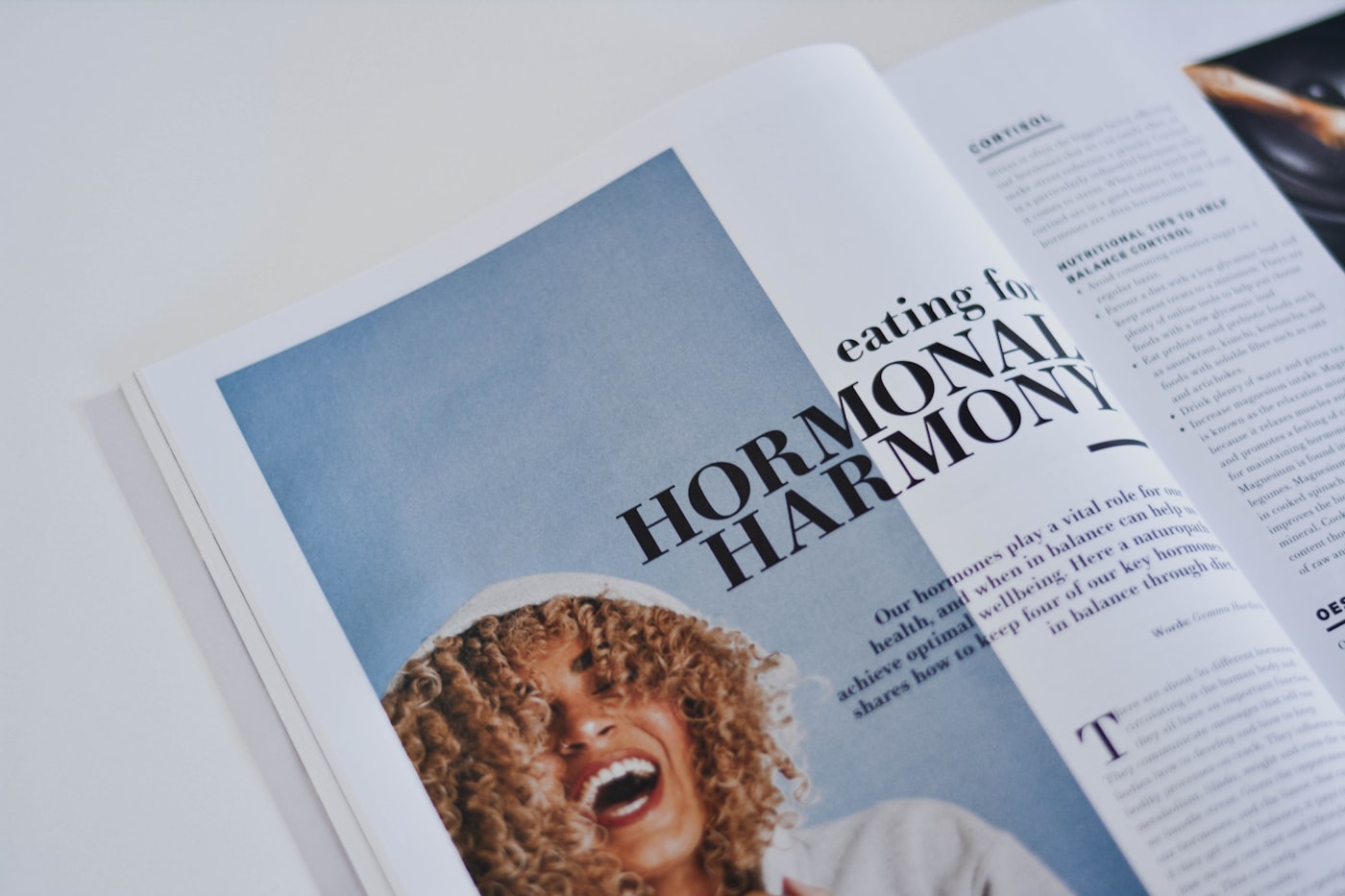An open magazine spread with editorial typography and photography